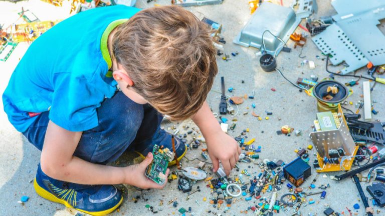 Boy with dismantled electronics
